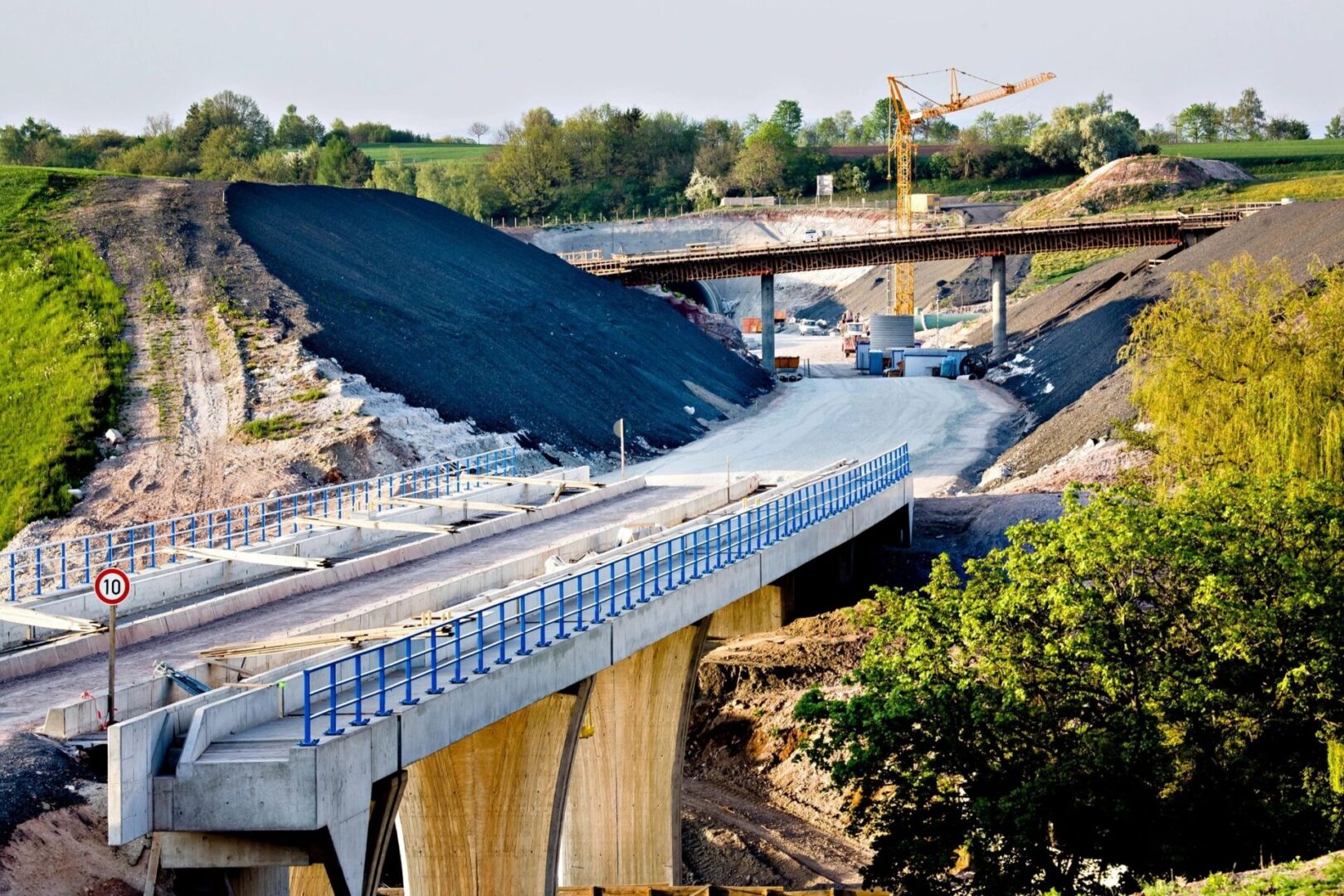 A large truck is on the side of a bridge.